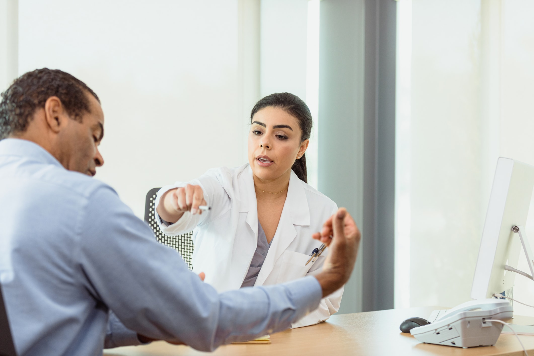 doctor pointing to a man's arm